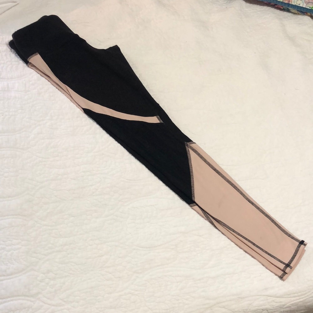 ALO yoga leggings in black and cream with mesh